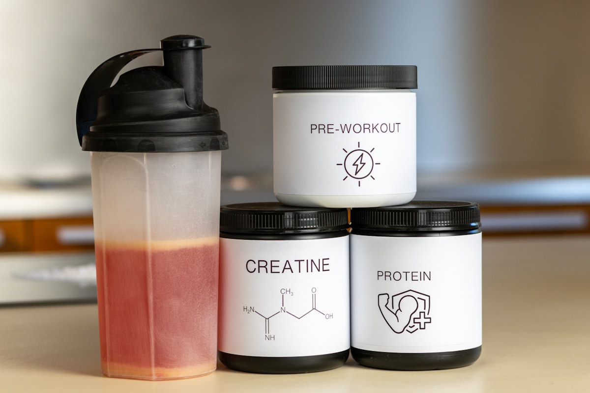 Athlete with sports nutrition and fitness equipment